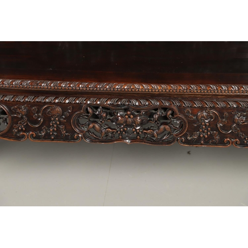 1267 - A CHINESE CARVED HARDWOOD HALL SEAT, QING DYNASTY, 19TH CENTURY. the shaped back with pierced triple... 