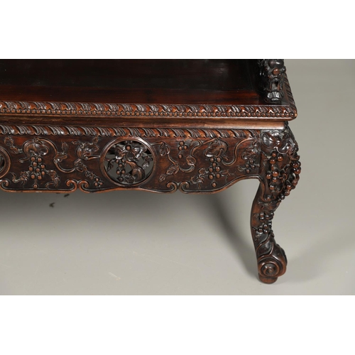 1267 - A CHINESE CARVED HARDWOOD HALL SEAT, QING DYNASTY, 19TH CENTURY. the shaped back with pierced triple... 