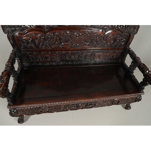 1267 - A CHINESE CARVED HARDWOOD HALL SEAT, QING DYNASTY, 19TH CENTURY. the shaped back with pierced triple... 