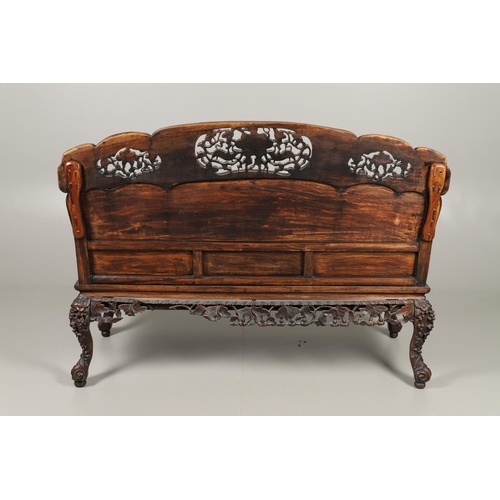 1267 - A CHINESE CARVED HARDWOOD HALL SEAT, QING DYNASTY, 19TH CENTURY. the shaped back with pierced triple... 