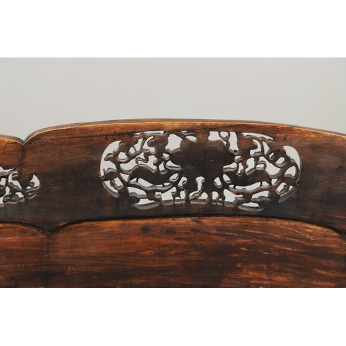 1267 - A CHINESE CARVED HARDWOOD HALL SEAT, QING DYNASTY, 19TH CENTURY. the shaped back with pierced triple... 