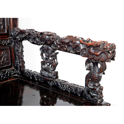 1267 - A CHINESE CARVED HARDWOOD HALL SEAT, QING DYNASTY, 19TH CENTURY. the shaped back with pierced triple... 