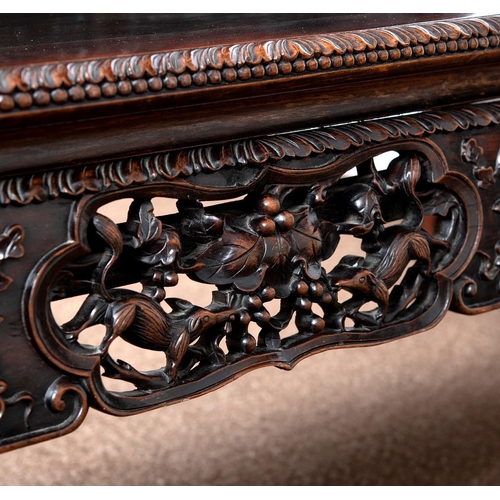 1267 - A CHINESE CARVED HARDWOOD HALL SEAT, QING DYNASTY, 19TH CENTURY. the shaped back with pierced triple... 