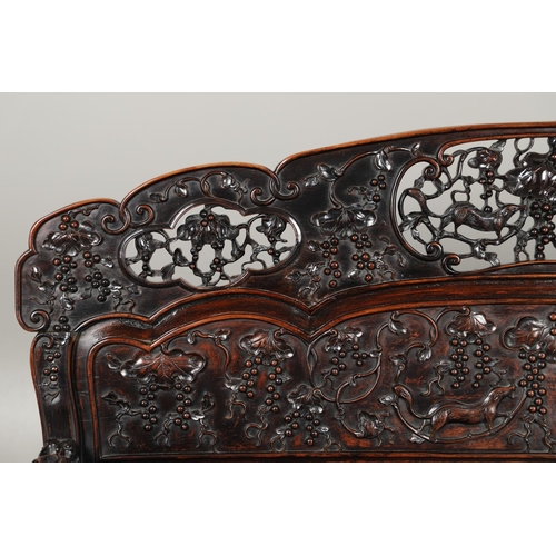 1267 - A CHINESE CARVED HARDWOOD HALL SEAT, QING DYNASTY, 19TH CENTURY. the shaped back with pierced triple... 