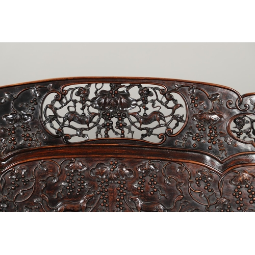 1267 - A CHINESE CARVED HARDWOOD HALL SEAT, QING DYNASTY, 19TH CENTURY. the shaped back with pierced triple... 