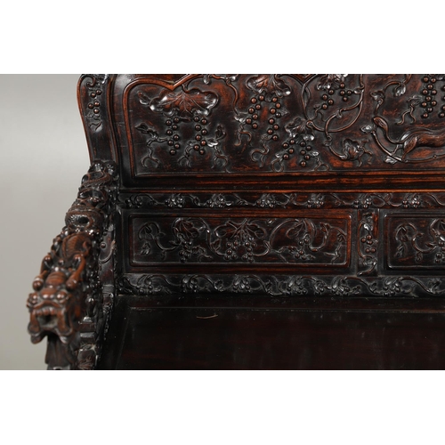 1267 - A CHINESE CARVED HARDWOOD HALL SEAT, QING DYNASTY, 19TH CENTURY. the shaped back with pierced triple... 