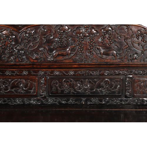 1267 - A CHINESE CARVED HARDWOOD HALL SEAT, QING DYNASTY, 19TH CENTURY. the shaped back with pierced triple... 