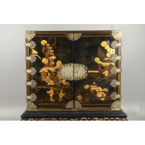 1268 - A CHINESE BLACK LACQUERED EXPORT CABINET. brass mounted, the cupboard doors and sides decorated with... 