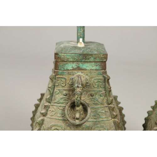 1271 - A PAIR OF CHINESE STYLE ARCHAIC BRONZE TABLE LAMPS. 20th century, with green painted 'patinated' fin... 