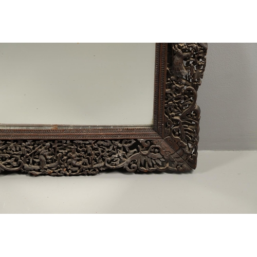 1272 - A PAIR OF EARLY 20TH CENTURY CHINESE CARVED WOODEN WALL MIRRORS. the frames carved and pierced with ... 