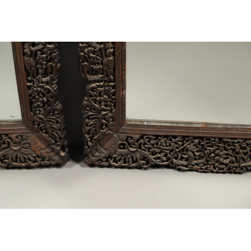 1272 - A PAIR OF EARLY 20TH CENTURY CHINESE CARVED WOODEN WALL MIRRORS. the frames carved and pierced with ... 