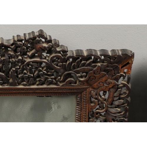 1272 - A PAIR OF EARLY 20TH CENTURY CHINESE CARVED WOODEN WALL MIRRORS. the frames carved and pierced with ... 