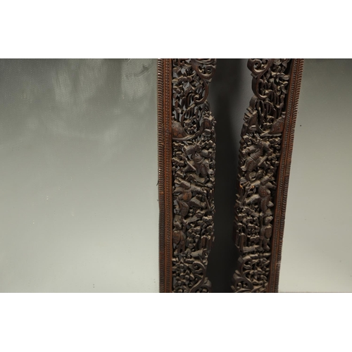 1272 - A PAIR OF EARLY 20TH CENTURY CHINESE CARVED WOODEN WALL MIRRORS. the frames carved and pierced with ... 