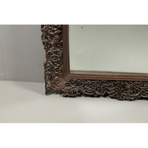 1272 - A PAIR OF EARLY 20TH CENTURY CHINESE CARVED WOODEN WALL MIRRORS. the frames carved and pierced with ... 