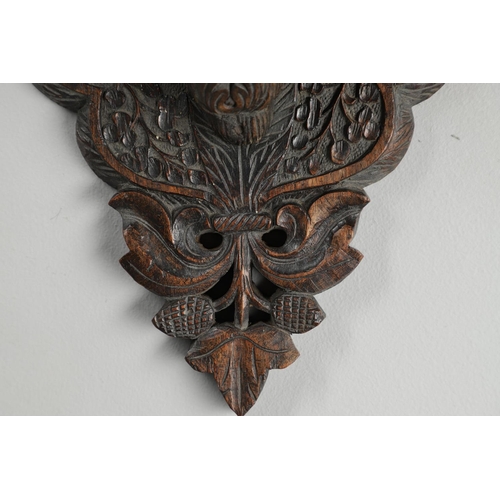 1273 - AN INDIAN CARVED HARDWOOD WALL SHELF. the ornately carved rectangular shelf on a peacock support wit... 