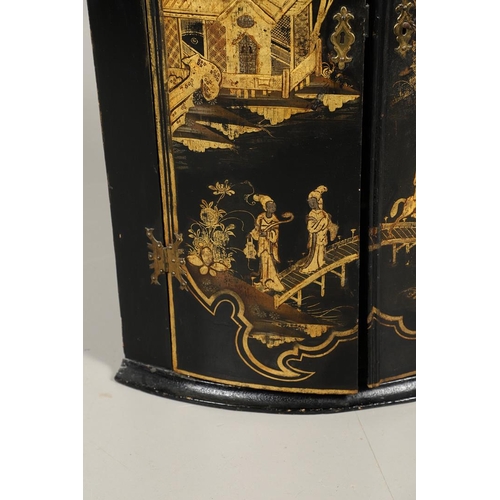 1276 - AN EARLY 20TH CENTURY BLACK CHINOISERIE HANGING CORNER CUPBOARD. the bow front doors gilt decorated ... 