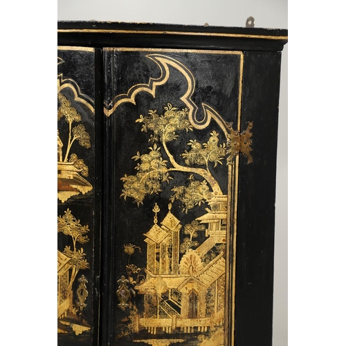 1276 - AN EARLY 20TH CENTURY BLACK CHINOISERIE HANGING CORNER CUPBOARD. the bow front doors gilt decorated ... 