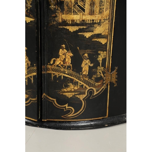 1276 - AN EARLY 20TH CENTURY BLACK CHINOISERIE HANGING CORNER CUPBOARD. the bow front doors gilt decorated ... 