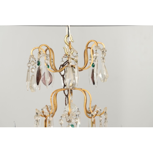 1279 - A 20TH CENTURY TWELVE BRANCH CRYSTAL CHANDELIER. with clear, amethyst and green cut glass drops susp... 