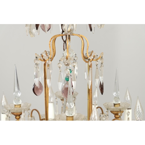 1279 - A 20TH CENTURY TWELVE BRANCH CRYSTAL CHANDELIER. with clear, amethyst and green cut glass drops susp... 