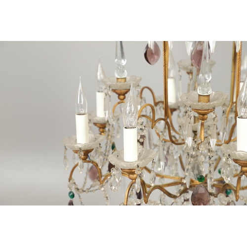 1279 - A 20TH CENTURY TWELVE BRANCH CRYSTAL CHANDELIER. with clear, amethyst and green cut glass drops susp... 