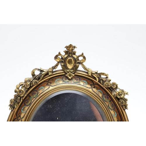 1287 - A SMALL FRENCH GILT METAL AND CHAMPLEVE ENAMEL WALL MIRROR. the oval dished frame with ribbon, scrol... 