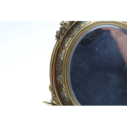 1287 - A SMALL FRENCH GILT METAL AND CHAMPLEVE ENAMEL WALL MIRROR. the oval dished frame with ribbon, scrol... 