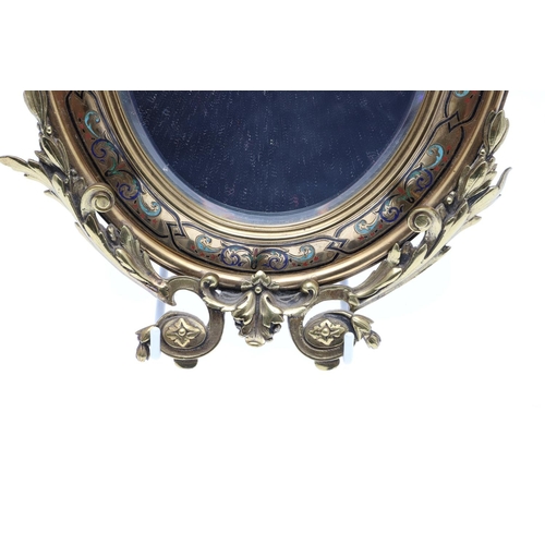 1287 - A SMALL FRENCH GILT METAL AND CHAMPLEVE ENAMEL WALL MIRROR. the oval dished frame with ribbon, scrol... 