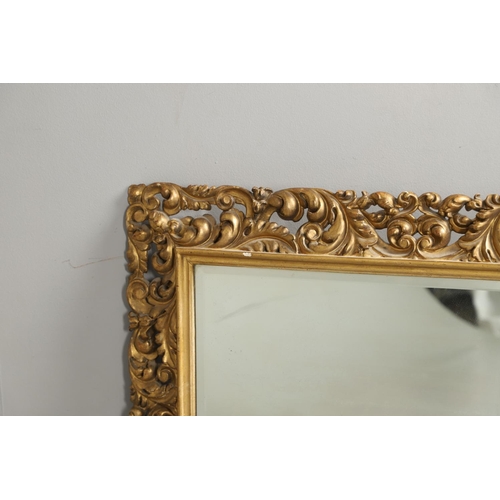 1289 - A 19TH CENTURY CONTINENTAL GILT FRAME MIRROR. the ornately moulded frame with foliate scrolls to a r... 