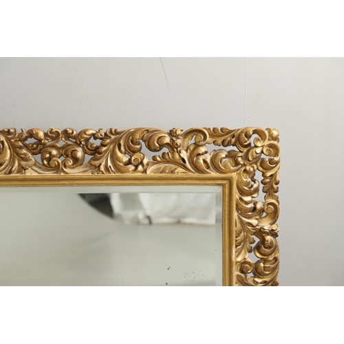 1289 - A 19TH CENTURY CONTINENTAL GILT FRAME MIRROR. the ornately moulded frame with foliate scrolls to a r... 