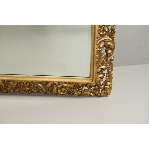 1289 - A 19TH CENTURY CONTINENTAL GILT FRAME MIRROR. the ornately moulded frame with foliate scrolls to a r... 