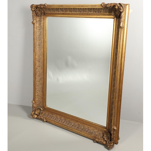 1293 - A LARGE 20TH CENTURY GILT WALL MIRROR. the ornate frame with moulded Classical shell, palmette and b... 