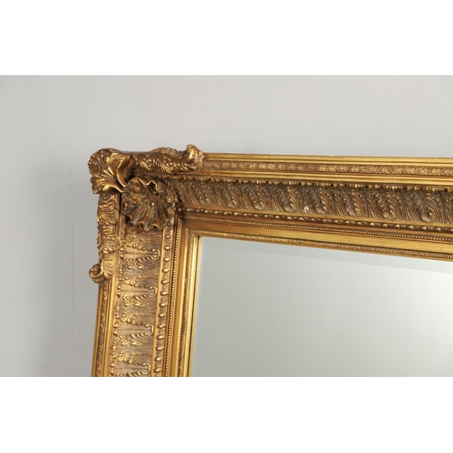 1293 - A LARGE 20TH CENTURY GILT WALL MIRROR. the ornate frame with moulded Classical shell, palmette and b... 