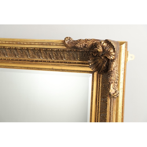 1293 - A LARGE 20TH CENTURY GILT WALL MIRROR. the ornate frame with moulded Classical shell, palmette and b... 