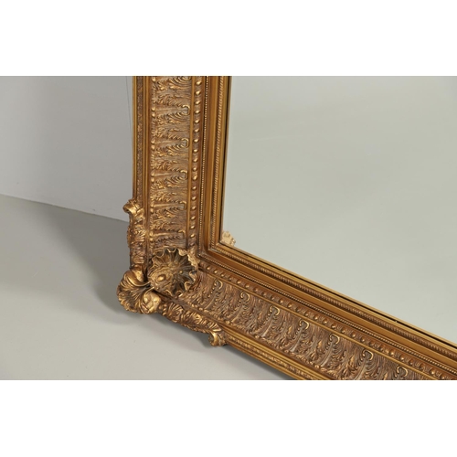 1293 - A LARGE 20TH CENTURY GILT WALL MIRROR. the ornate frame with moulded Classical shell, palmette and b... 