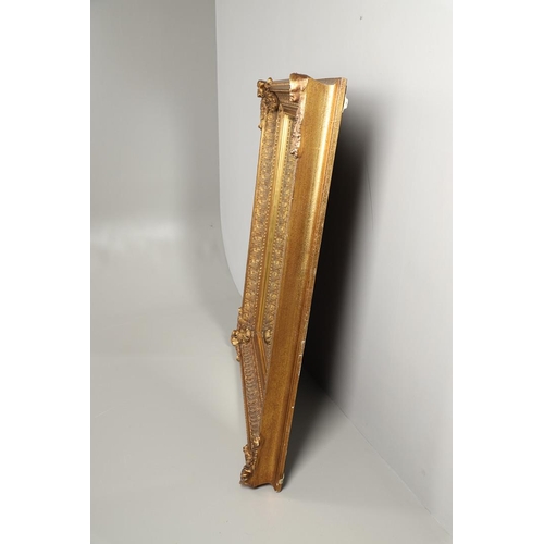 1293 - A LARGE 20TH CENTURY GILT WALL MIRROR. the ornate frame with moulded Classical shell, palmette and b... 