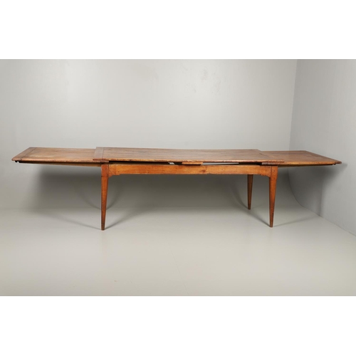 1295 - A 19TH CENTURY FRENCH FRUITWOOD DRAWLEAF FARMHOUSE TABLE. the six plank top to a single drawer at on... 