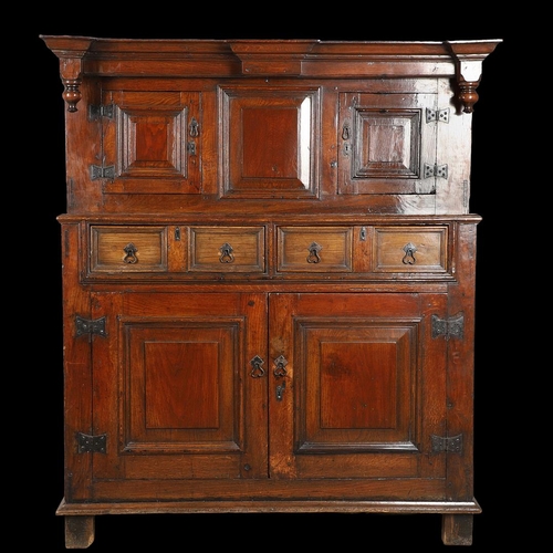 1298 - AN 18TH CENTURY OAK COURT CUPBOARD. the panelled top section with twin cupboards enclosing a vacant ... 