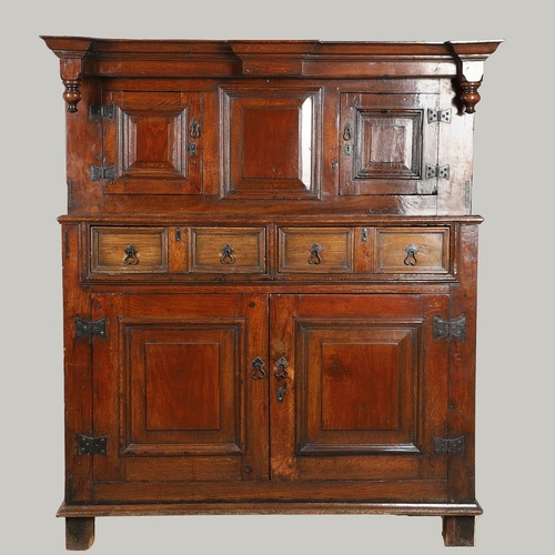 1298 - AN 18TH CENTURY OAK COURT CUPBOARD. the panelled top section with twin cupboards enclosing a vacant ... 