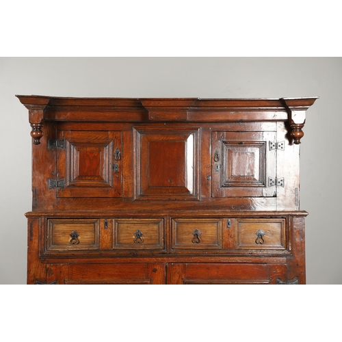 1298 - AN 18TH CENTURY OAK COURT CUPBOARD. the panelled top section with twin cupboards enclosing a vacant ... 