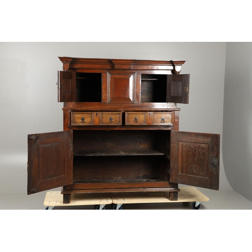 1298 - AN 18TH CENTURY OAK COURT CUPBOARD. the panelled top section with twin cupboards enclosing a vacant ... 