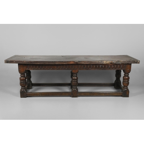 1299 - A 17TH CENTURY OAK REFECTORY TABLE. the single plank top with three unusual cut out hearts above a c... 