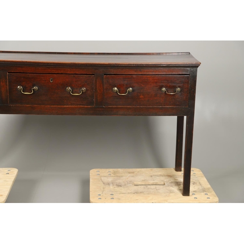 1300 - A GEORGE II OAK DRESSER BASE. the plank top over three drawers with brass handles and square legs, h... 