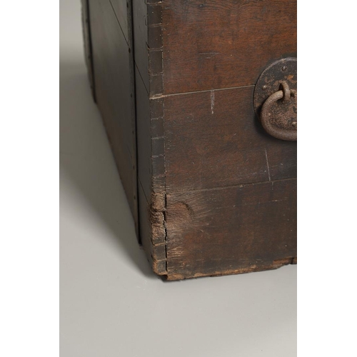 1303 - AN 18TH CENTURY OAK AND IRON BOUND SILVER CHEST. the hinged plank lid and sides with forged iron han... 