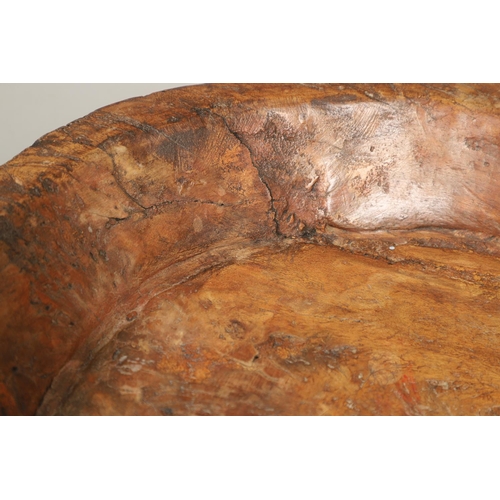 1304 - A LARGE RUSTIC CARVED HARDWOOD BOWL. possibly African, height 10cm, diameter 51cm.