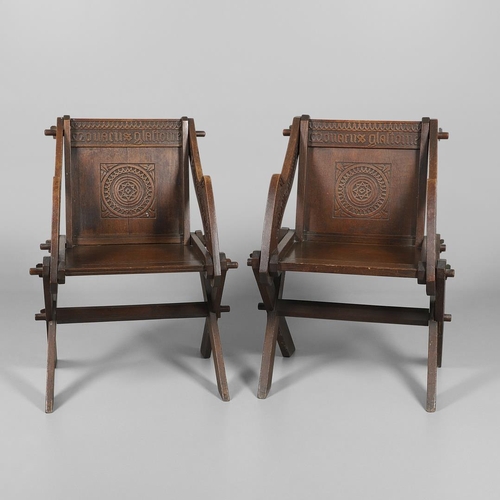 1309 - A PAIR OF VICTORIAN OAK GLASTONBURY CHAIRS. of typical pegged construction, the carved panel back ce... 