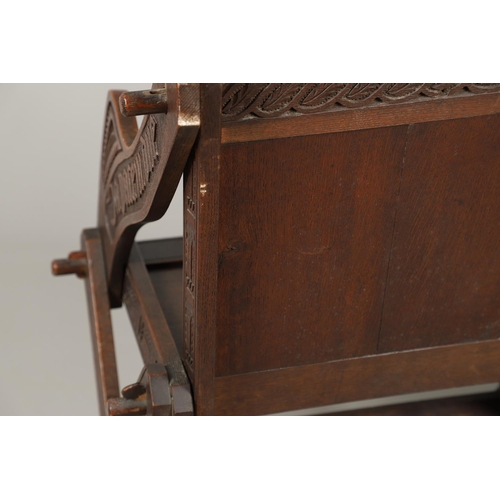 1309 - A PAIR OF VICTORIAN OAK GLASTONBURY CHAIRS. of typical pegged construction, the carved panel back ce... 