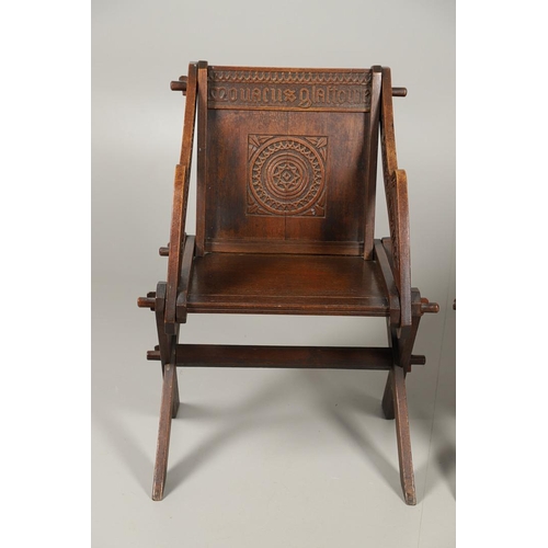 1309 - A PAIR OF VICTORIAN OAK GLASTONBURY CHAIRS. of typical pegged construction, the carved panel back ce... 