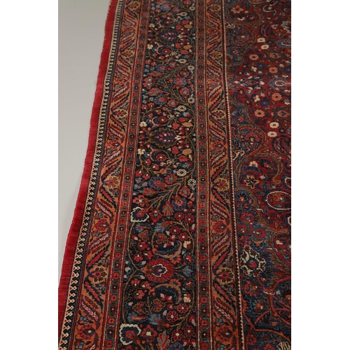 1310 - A MASHAD CARPET, NORTH EAST PERSIA, CIRCA 1920. the raspberry field richly decorated with vines cent... 