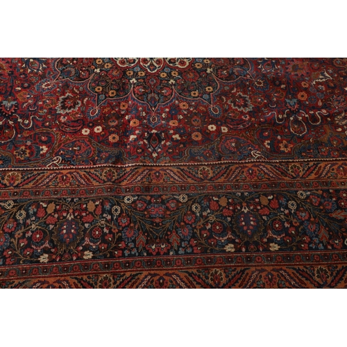 1310 - A MASHAD CARPET, NORTH EAST PERSIA, CIRCA 1920. the raspberry field richly decorated with vines cent... 